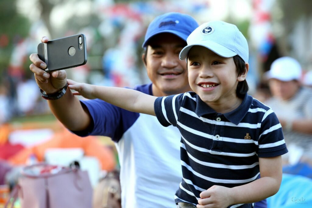 A boy and his father taking a selfie together