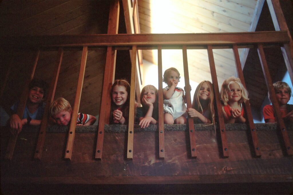 Children peeking through a stair railing