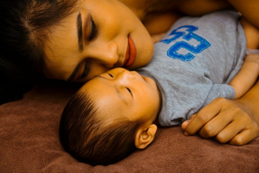 A mother and her baby dozing together at home
